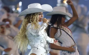Beyoncé performing on stage during the Cowboy Carter Tour 2025 with mechanical bull and pyrotechnics